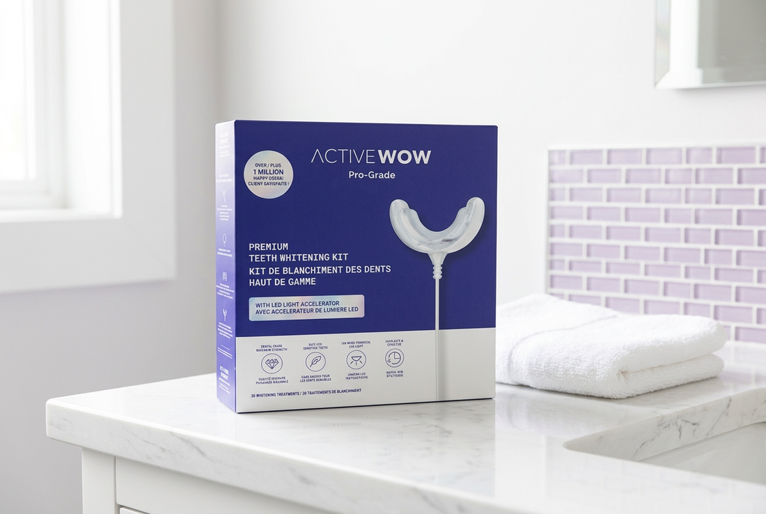 Active Wow Premium Teeth Whitening Kit in indigo-and-white packaging beside a folded white towel on a bathroom vanity with lavender accents.