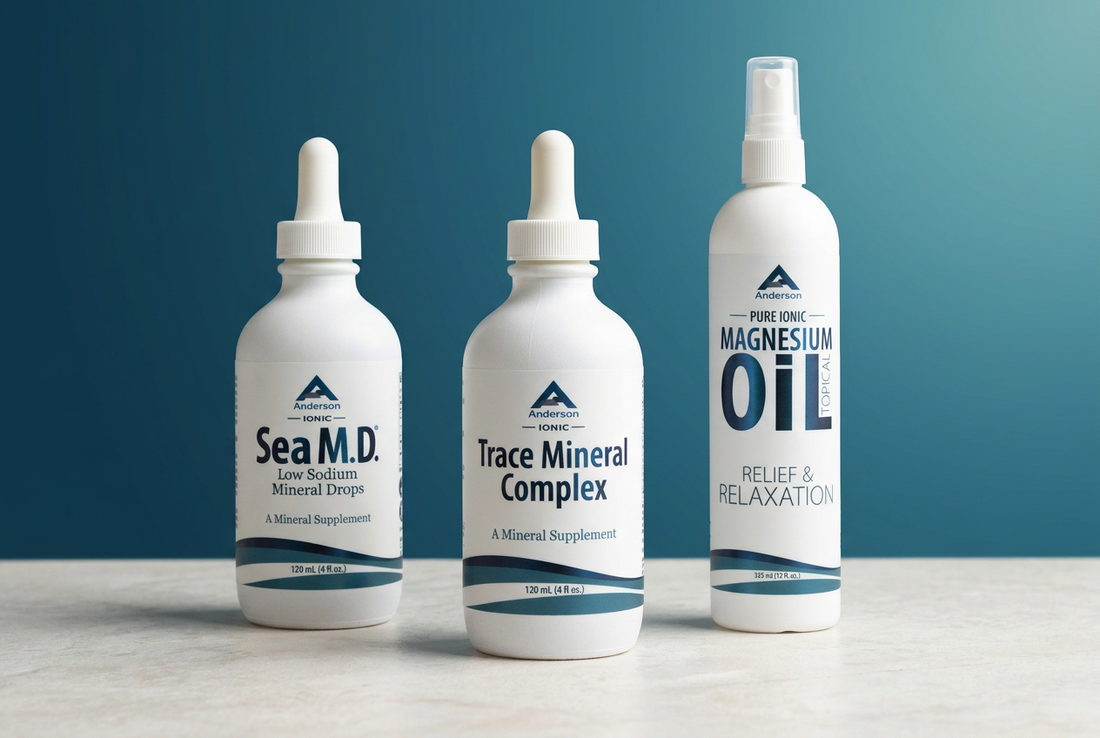 Anderson Health Solutions Sea M.D. and Trace Mineral Complex dropper bottles beside a Magnesium Oil spray on pale stone against a lake-blue and teal background.