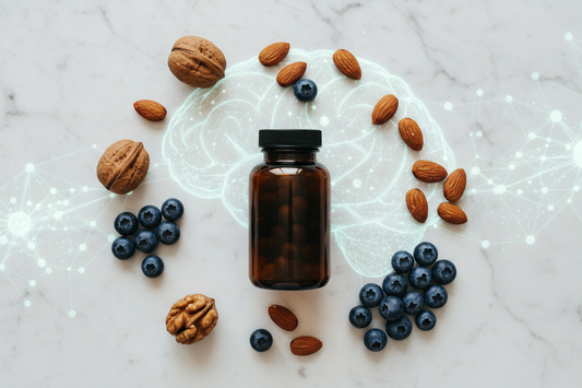 Dark supplement bottle, walnuts, almonds, and blueberries on white marble — CoQ10, mitochondria, and brain health science