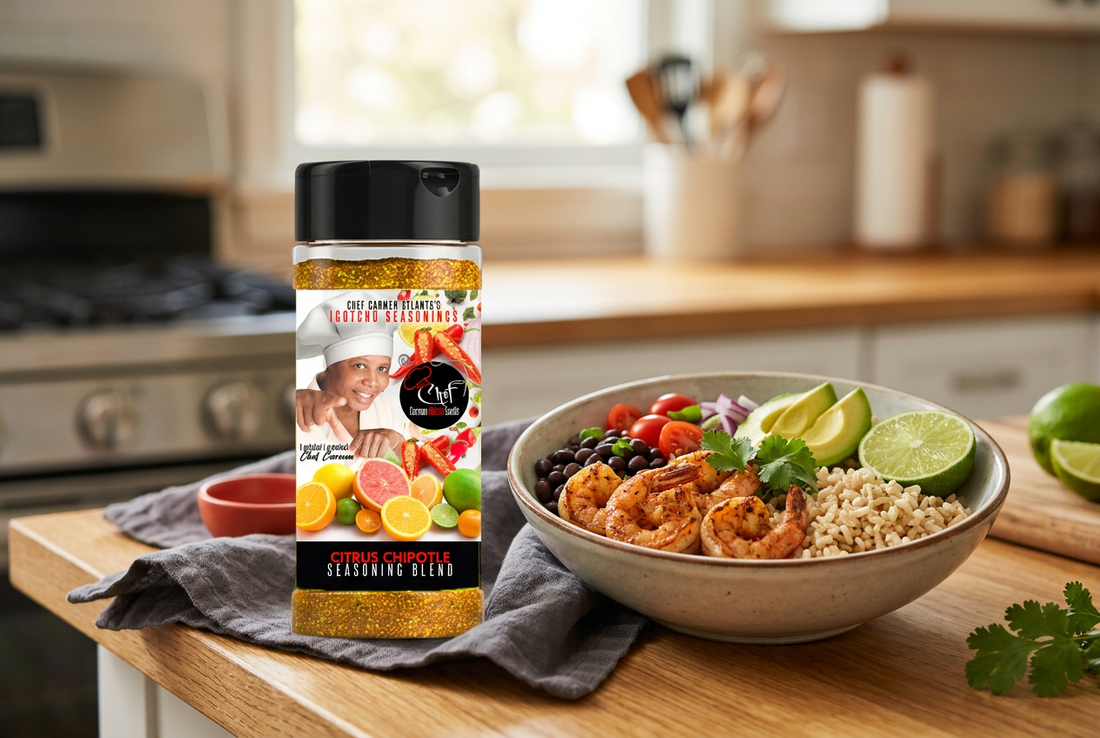 Igotchu Citrus Chipotle seasoning bottle beside a shrimp and rice bowl with avocado, tomatoes, black beans, and lime on a kitchen counter.