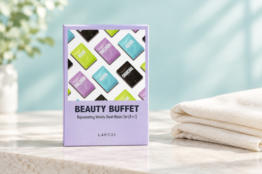 LAPCOS Beauty Buffet lavender sheet-mask variety box beside ivory linen on a white stone surface with a soft aqua background.