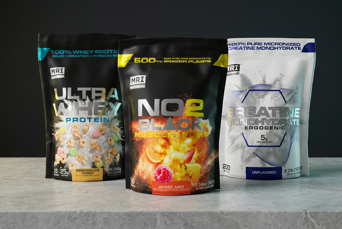 MRI Performance NO2 Black, Ultra Whey Protein, and Micronized Creatine pouches arranged on pale gray stone against a charcoal background with yellow and cyan accents.