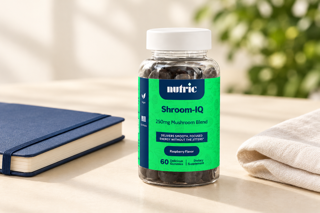 Nutric Shroom-IQ gummy bottle with a bright-green label beside a navy notebook and ivory linen on a cream tabletop.