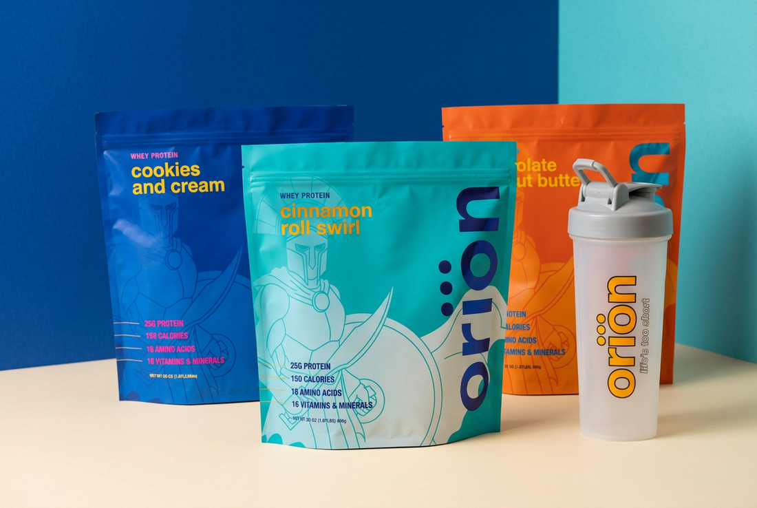 Orion Supplements whey protein bags in cobalt blue, orange, and turquoise beside a translucent white Orion shaker on a cream surface against a blue background.