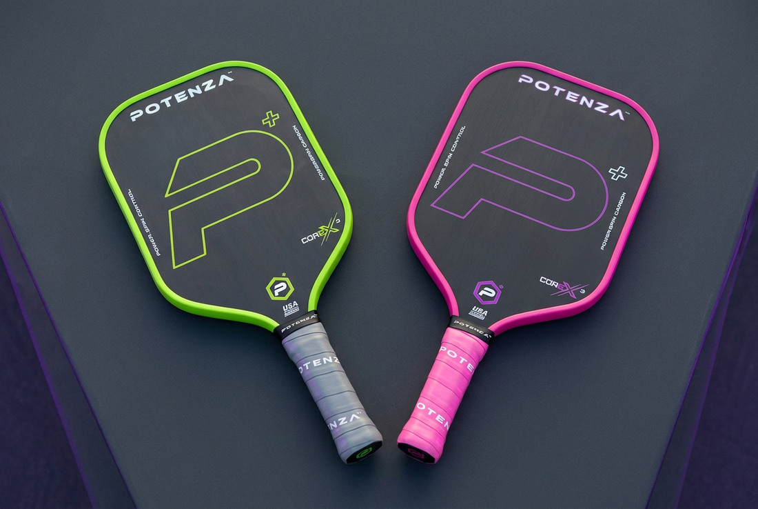 Potenza Pickleball P+ PowerSpin Carbon COREx3 paddles in neon green and neon pink displayed side by side on a charcoal surface.