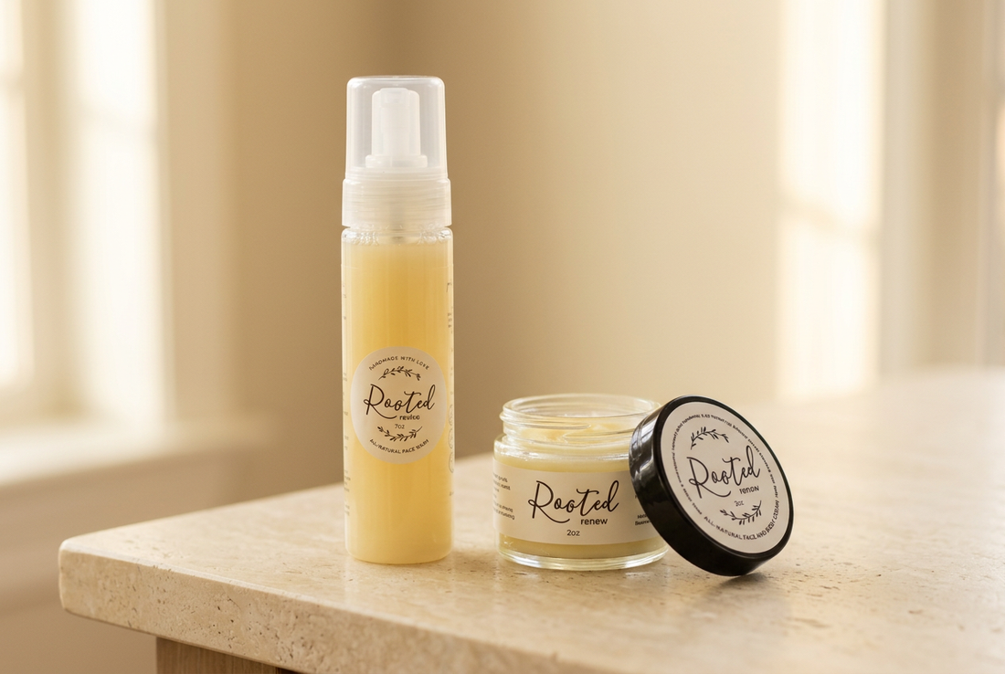Rooted For Good Revive face wash beside an open jar of Renew face and body cream on a warm ivory vanity surface.