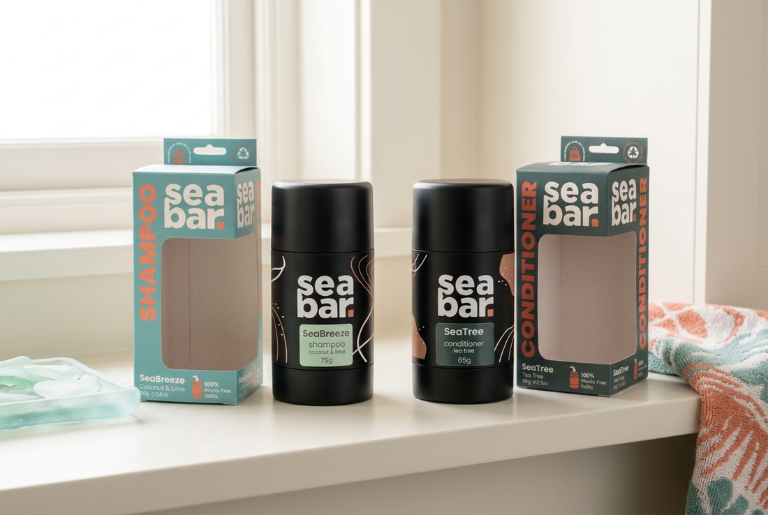 SeaBar SeaBreeze shampoo and SeaTree conditioner refillable applicators with their seafoam and green cartons on an ivory bathroom shelf.
