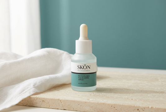  SKÖN Matrixyl 3000 serum bottle with a white dropper and teal label beside white linen on a cream stone surface.