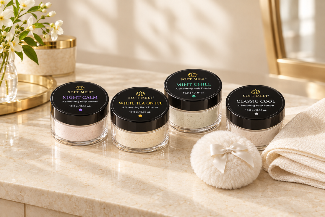 Soft Melt Night Calm, White Tea on Ice, Mint Chill, and Classic Cool body-powder jars beside a white powder puff and ivory linen on a cream vanity surface.