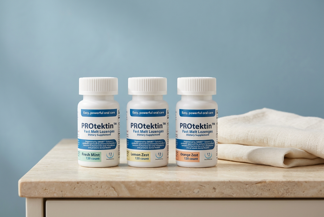 Three PROtektin Fast Melt Lozenges bottles in Fresh Mint, Lemon Zest, and Orange Zest beside ivory linen on a cream stone surface.