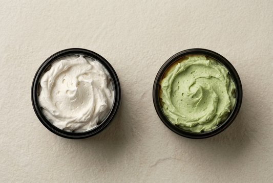 Open Wild Haven Skin Naked Whip and Matcha Whip jars showing ivory and pale green whipped textures on a warm ivory surface.