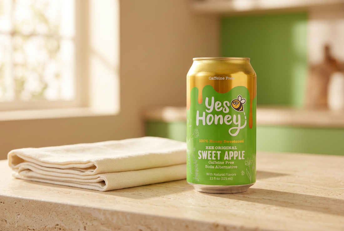 Yes Honey Sweet Apple green and gold soda can beside ivory linen on a cream kitchen counter.