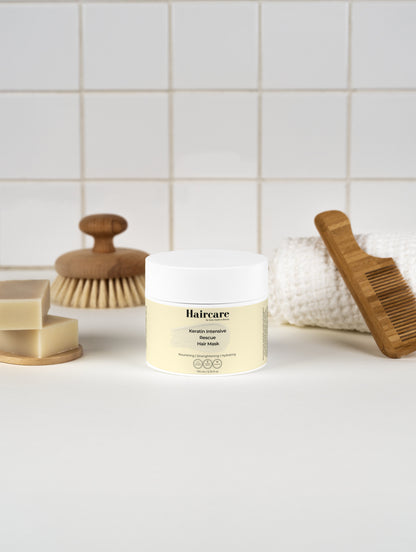 Keratin Intensive Rescue Hair Mask applied to hair — reduces breakage, restores shine, white floral scent