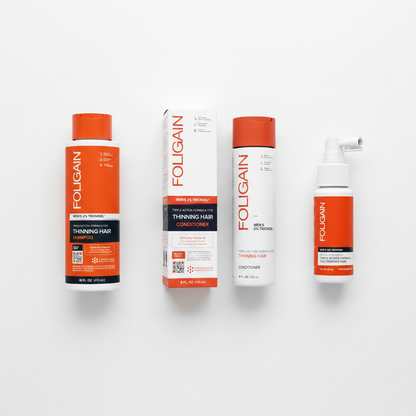 FOLIGAIN Men's TRIOXIDIL hair care bundle on white surface — shampoo, conditioner and topical serum top-down view