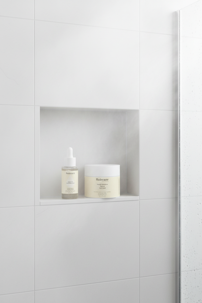 Scalp Care Exfoliating Serum and Keratin Intensive Rescue Hair Mask on a white tile shower niche shelf with steam and water droplets — scalp and hair repair bundle by Daily Health & Beauty