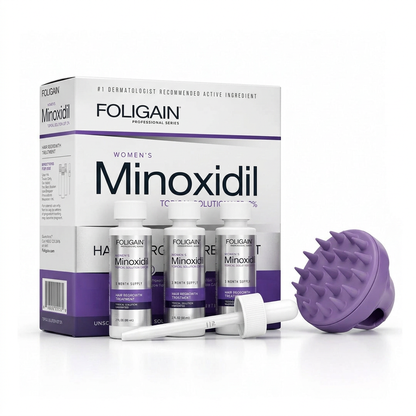 FOLIGAIN women's minoxidil bundle with three bottles, carton, dropper and purple scalp massager tilted to show bristles.