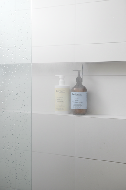 Colour Care Shampoo Peachy Grapefruit Zest and Mens 2-in-1 Hair & Body Wash on a white tile shower niche shelf with steam — shared bathroom hair care bundle by Daily Health & Beauty
