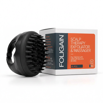 FOLIGAIN black Scalp Therapy Exfoliator and Massager with soft silicone bristles, finger-grip handle and retail carton.