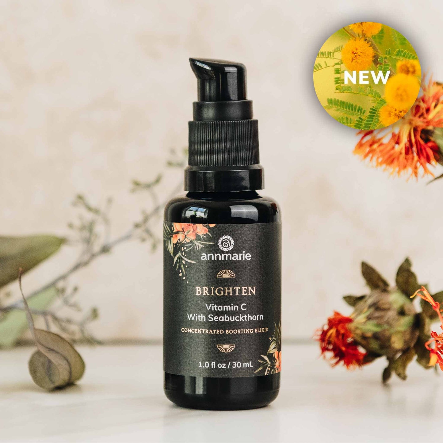 Black bottle of Annmarie Skin Care with floral design on a neutral background